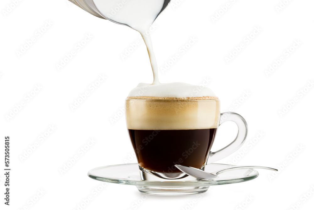 Wall mural making cappuccino in glass cup with milk frother on white background.