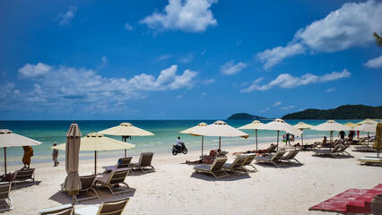 Phu Quoc island, Vietnam - March 31, 2019: A beach of white sand, equipped with sun loungers and umbrellas for relaxing. Beautiful coast of the South China Sea