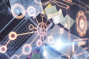 Social network hologram drawings over computer on the desktop background. Top view. Double exposure.