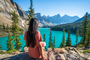 Young girl enjoying Moraine Lake beautiful scenery. Banff National Park nature landscape. Canadian Rockies summer time. Alberta, Canada. - obrazy, fototapety, plakaty