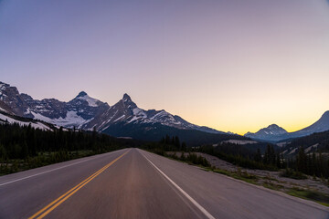 Naklejka premium Driving on Icefields Parkway at twilight time. Alberta Highway 93. Jasper National Park, Canada. 