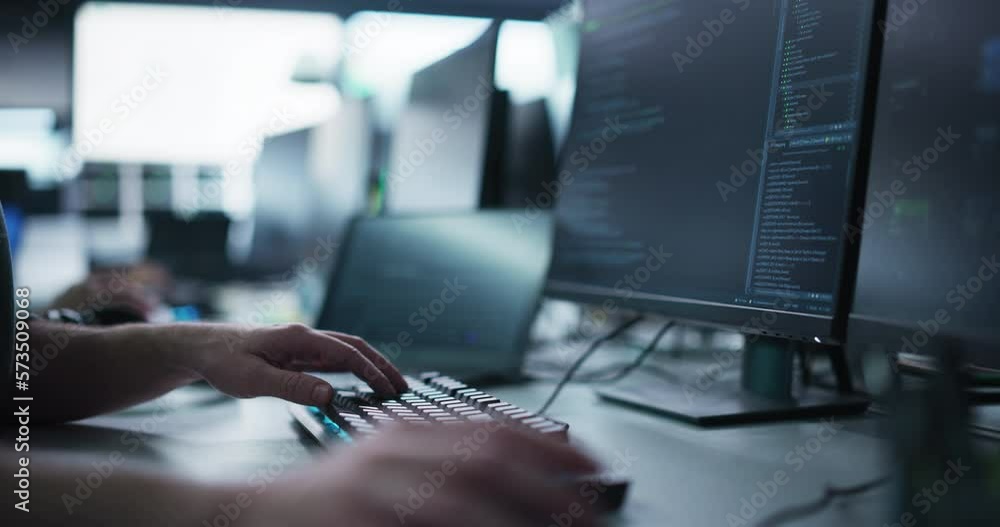 Fototapete Close Up of a Software Developer Working on a Computer, Typing Programming Code on a Stylish Keyboard with Neon Backlight. Professional Employee Doing Work in a Cyber Security Technology Company