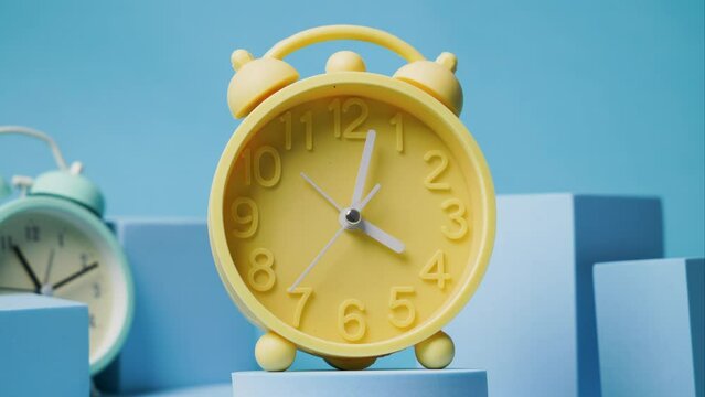 Vintage alarm clock timelapse: This stock footage features a close-up shot of a vintage alarm clock as time passes by quickly. The clock's hands move quickly as the seconds tick away, making for an