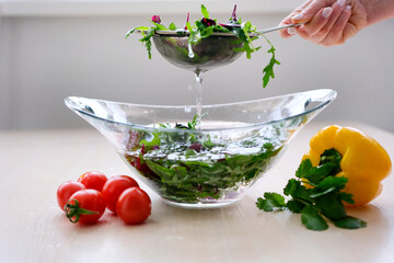Super Slow Motion Shot of Flying Cuts of Colorful Vegetables and Water Drops Close up of hands people washing vegetables by tap water at the sink in kitchen to clean ingredient prepare a fresh salad