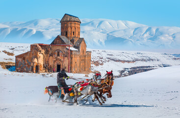 Horses pulling sleigh in winter - Ani Ruins, Ani is a ruined and  medieval Armenian city - Kars, Turkey