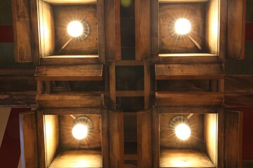 Stylish pendant lamps on ceiling in hotel room, bottom view