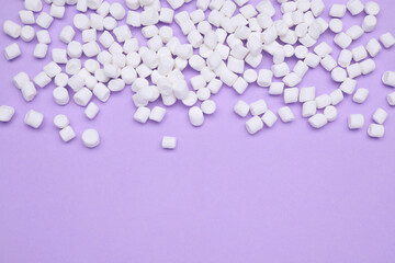 Delicious sweet marshmallows on purple background, flat lay. Space for text