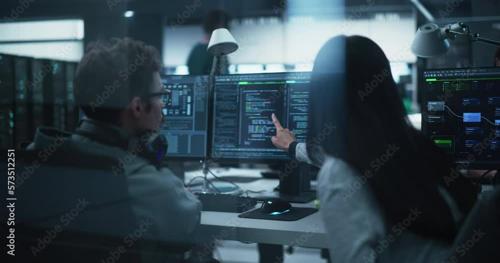 Fototapete Young Team of Specialists Working on Desktop Computers and Having a Conversation at a Workplace. Female and Male Software Developers Discussing a Solution for Their Artificial Intelligence Project