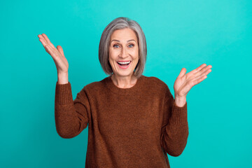 Photo of positive joyful lovely senior lady wear brown trendy clothes raise arms celebrate victory...