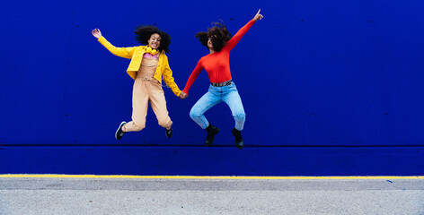 Young happy women dancing and having fun outdoor