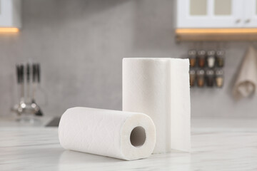 Rolls of paper towels on white marble table in kitchen