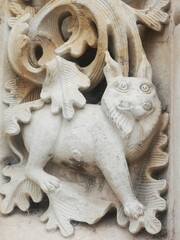 cat carved in stone on the door of the church