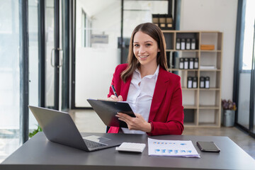 Marketing, Finance, Accounting, Planning, Team female accountant using laptop calculator and documents, charts, graphs in the analysis of the company is profit.