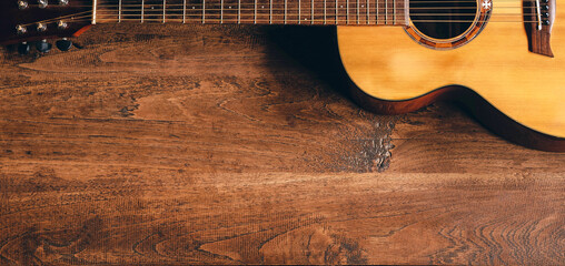 Top view of classical guitar on old wooden background.dark tone