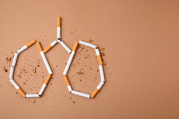 No smoking concept. Lungs made of cigarettes and dry tobacco on brown background, flat lay with space for text