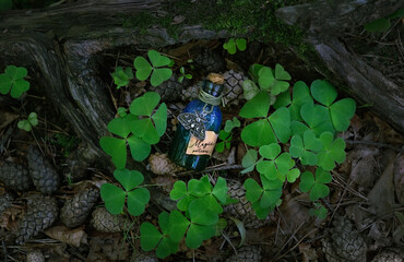 magic witch bottle with amulet on natural forest background. Witchcraft, mysterious spiritual practice. pagan Wiccan traditions. esoteric ritual for Midsummer, Litha. top view