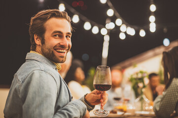 Family and friends celebrating at dinner on a rooftop terrace