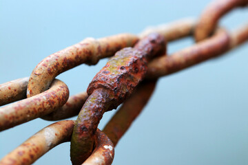 Old rusty chain lock, blue sky back ground close up macro photography.