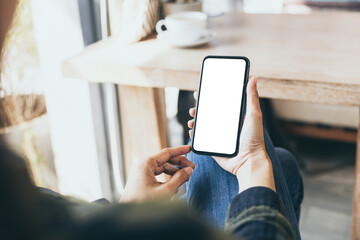 cell phone blank white screen mockup.hand holding texting using mobile on desk at office.background empty space for advertise.work people contact marketing business,technology