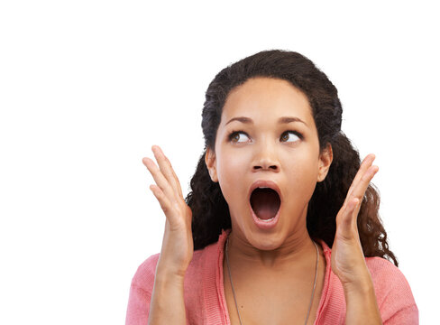 An astonished young spanish girl with wow facial expressions with open mouth and a OMG gesture looking sideways in disguise at the copyspace for discount and offers isolated on a PNG background.