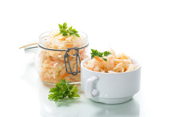 Sauerkraut with carrots and spices in a glass jar