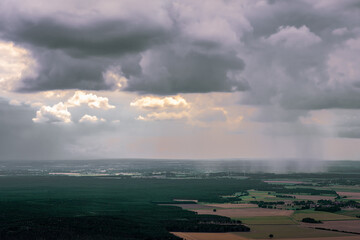 Aerial view of forests above a dark rain cloud Rain cloud
