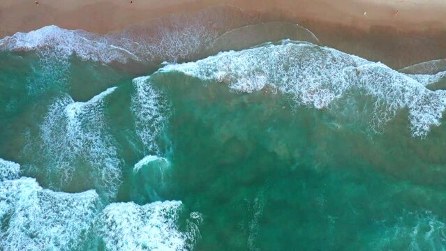 Slowly moving to the right aerial top down drone shot of the beach and ocean riptide currents at Bondi beach Australia