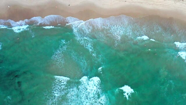 Moving to the right aerial top down drone shot of the beach and ocean riptide currents at Bondi beach Australia