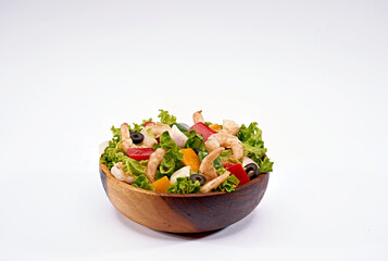 beef salad with a mushroom on a wooden bowl on isolated white background