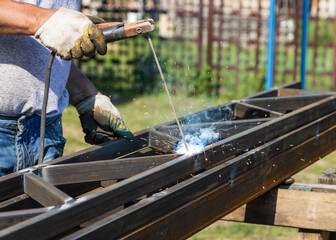 man working with a welding machine in nature