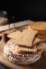 Rye crispbreads, rice cakes and rusks on table, closeup
