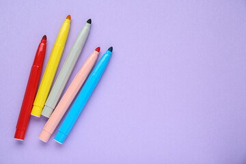 Different colorful markers on light background, flat lay. Space for text