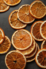 Dry orange slices on black table, flat lay