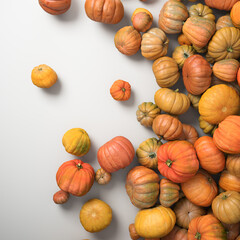 Autumn composition of orange pumpkins on white table background.