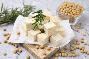 Delicious tofu cheese, rosemary and soybeans on light gray textured table, closeup