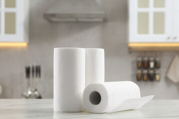 Rolls of paper towels on white marble table in kitchen