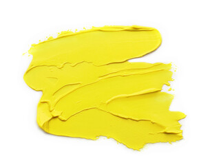 Yellow oil paint strokes on white background, top view