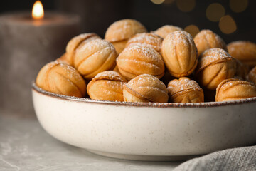 Bowl of delicious nut shaped cookies on grey table, closeup