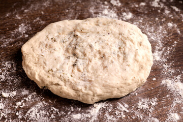 Fresh dough on wooden table, closeup. Cooking grissini