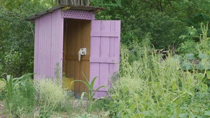 Wooden back yard toilet, rudimentary rural lifestyle, close to green nature