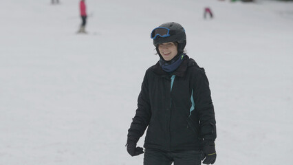 Fototapeta na wymiar Happy woman skiing on winter mountain slope