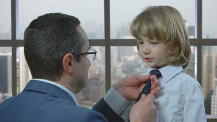 Man arrange child tie, father and son close talking, business talk, smart toddler pointing head with finger, office window panorama
