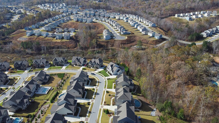 Row of new developments houses in master planned subdivision with lush green trees and natural...