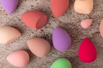 Beauty blender. Colorful beauty sponges on a marble background. Cosmetic tool for applying foundation, concealer. Place for text. Place to copy.