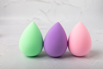 Beauty blender. Colorful beauty sponges on a marble background. Cosmetic tool for applying foundation, concealer. Place for text. Place to copy.