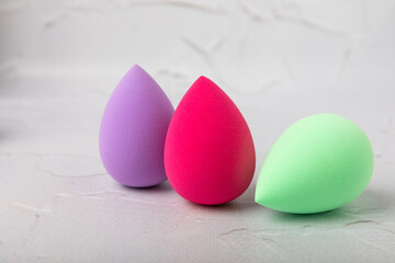 Beauty blender. Colorful beauty sponges on a marble background. Cosmetic tool for applying foundation, concealer. Place for text. Place to copy.