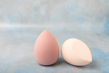 Beauty blender. Colorful beauty sponges on a marble background. Cosmetic tool for applying foundation, concealer. Place for text. Place to copy.