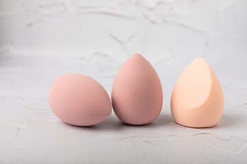 Beauty blender. Colorful beauty sponges on a marble background. Cosmetic tool for applying foundation, concealer. Place for text. Place to copy.
