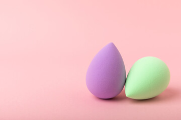 Beauty blender. Colorful beauty sponges on a pink background. Cosmetic tool for applying foundation, concealer. Place for text. Place to copy.