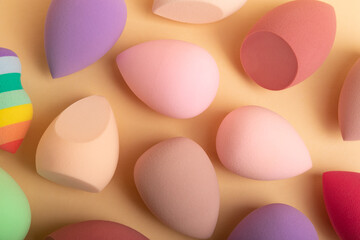 Beauty blender. Colorful beauty sponges on a pink background. Cosmetic tool for applying foundation, concealer. Place for text. Place to copy.